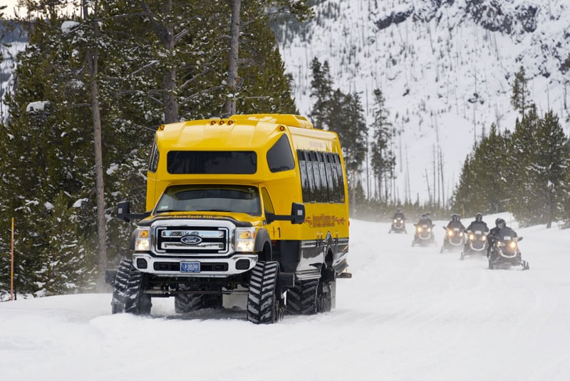 riding a snowmobile through yellowstone national park is one of the top things to do in winter